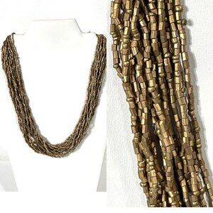 Multi-strand gold beaded necklace.